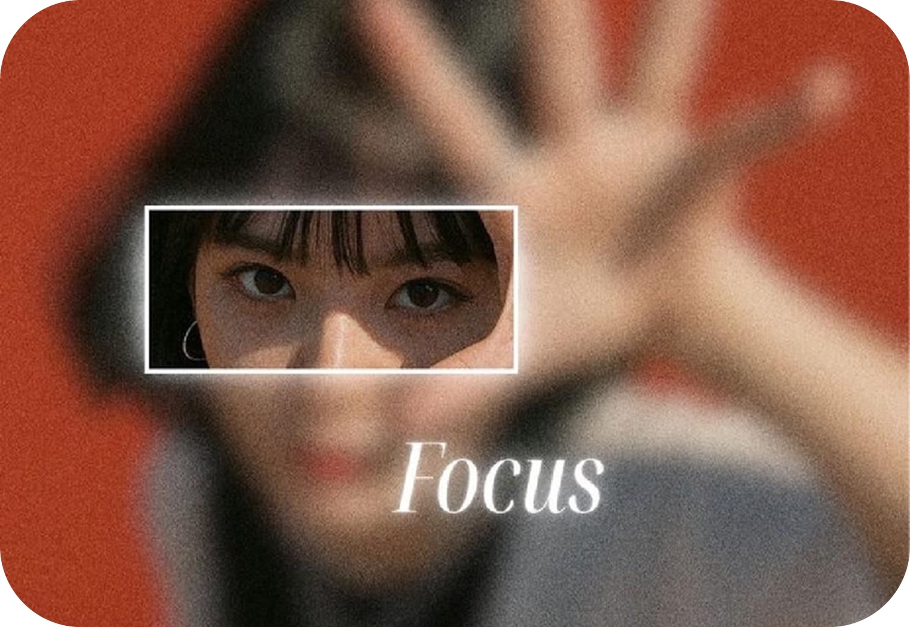 A blurred hand raised toward camera with a sharp rectangular focus window over the eyes, and the word Focus in italic type.